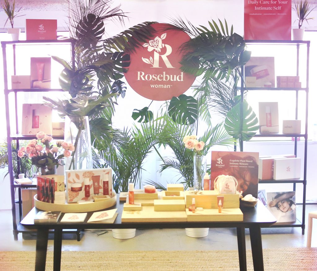 Talk about open and inviting: Rosebud Woman used a combination of simple elements at its trade show booth, including table, shelves, plants, natural light and signage, to create a sophisticated, accessible environment.